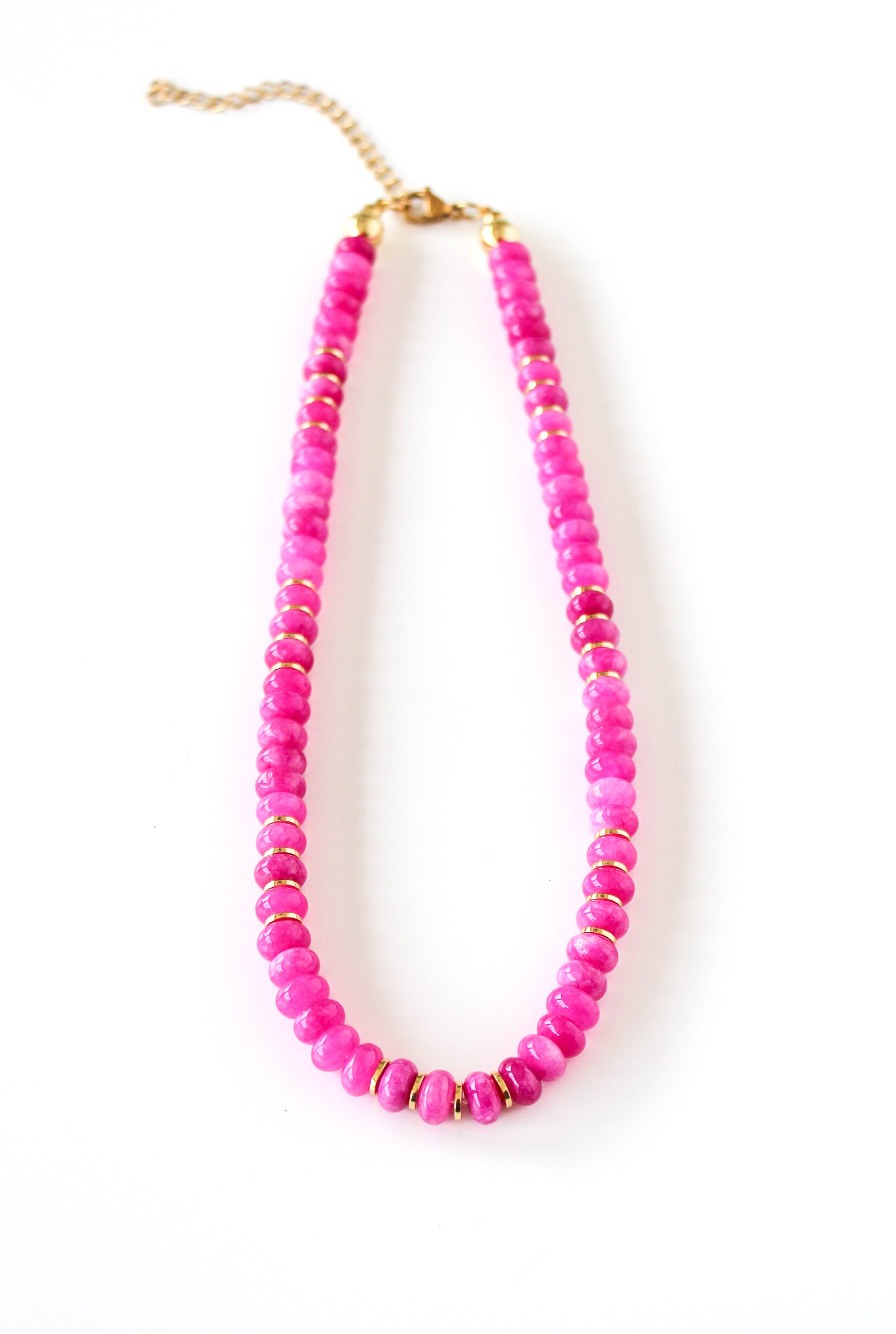 a pink beaded necklace on a white background
