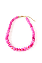 a pink beaded necklace on a white background