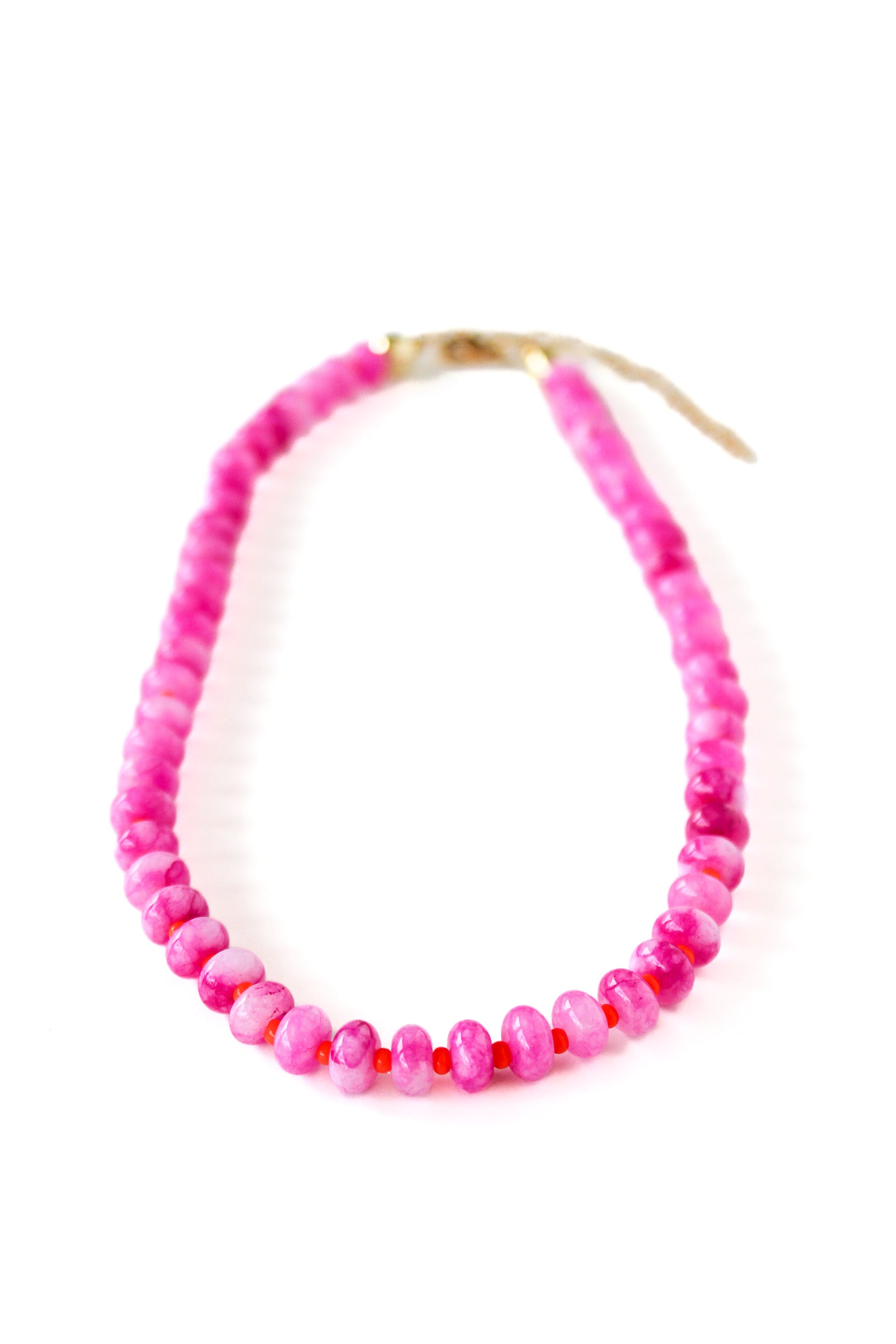 a pink beaded necklace on a white background