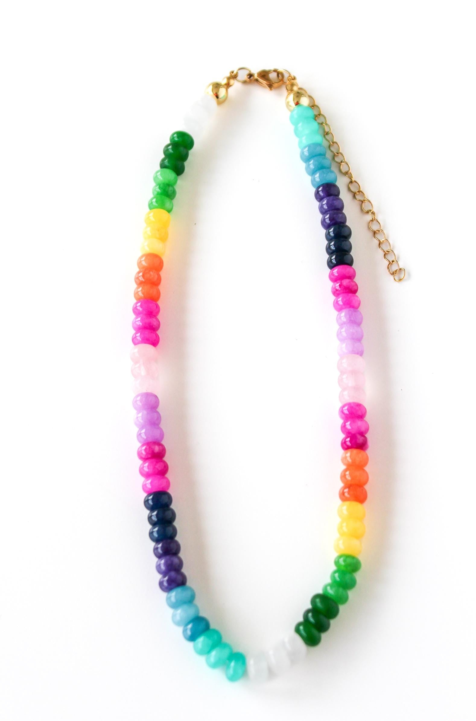 a multicolored beaded necklace on a gold chain