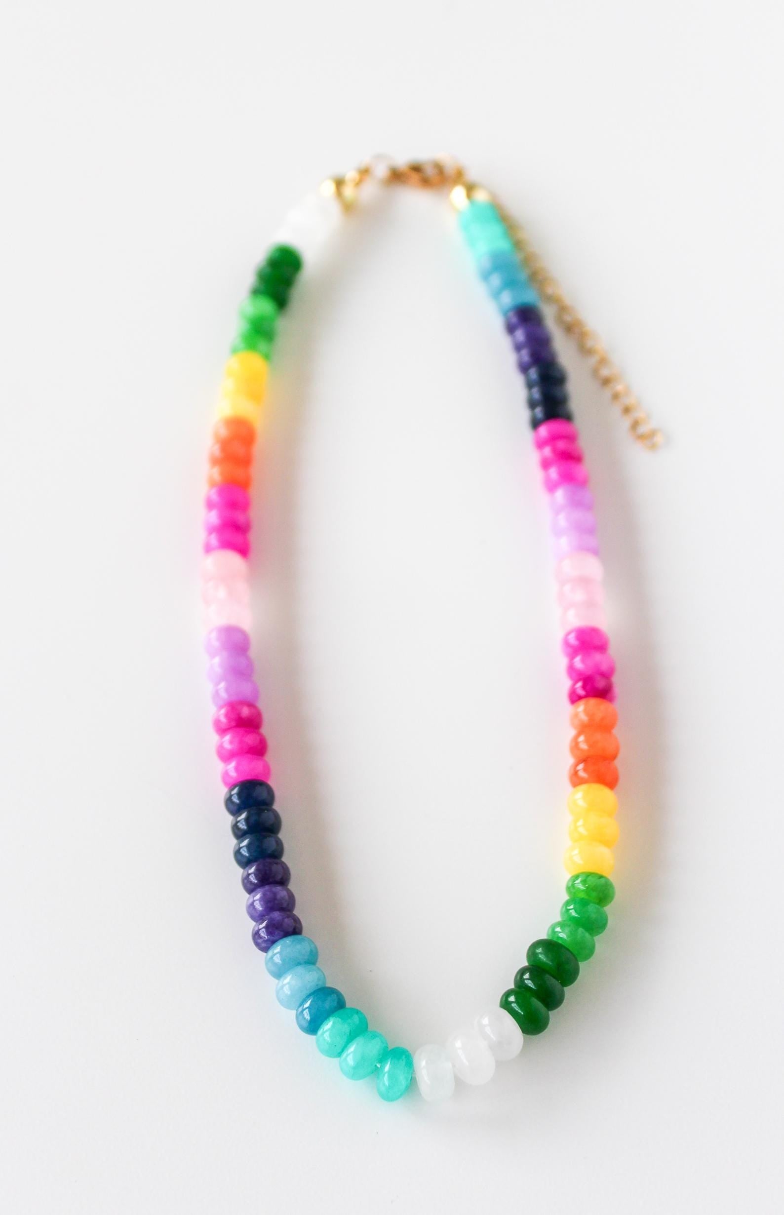 a multicolored beaded necklace on a white background