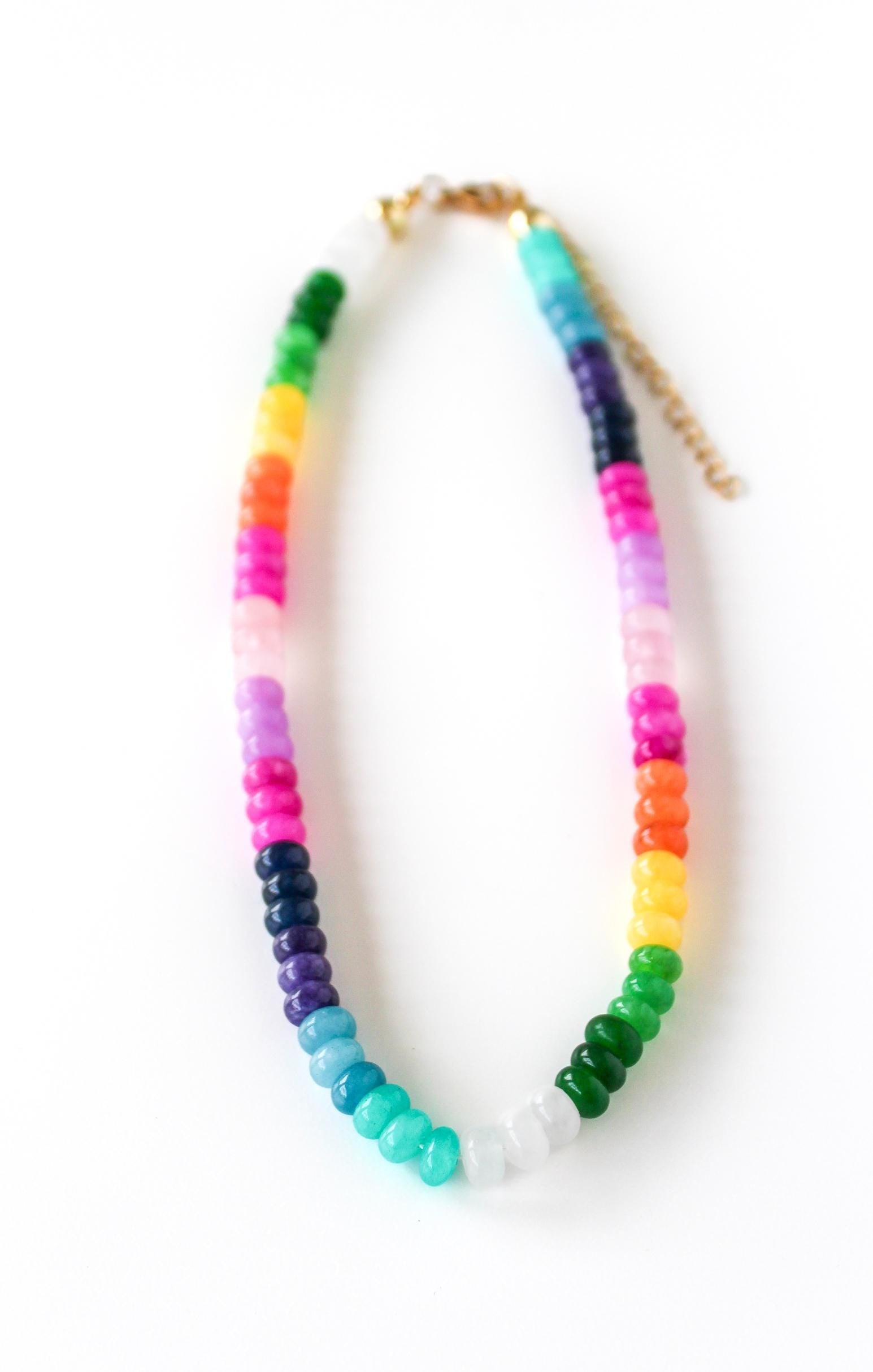 a multicolored beaded necklace on a white background