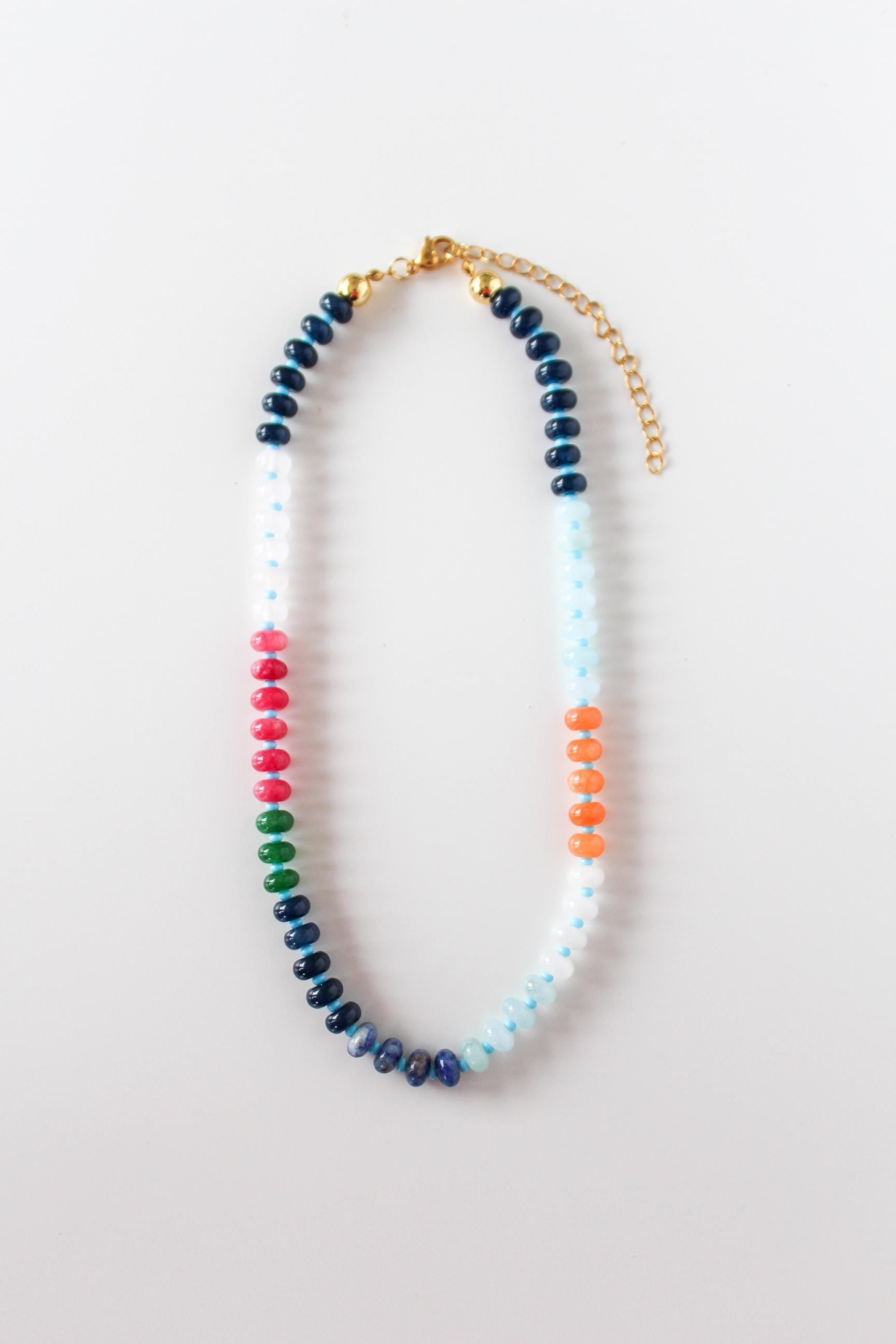 a multicolored beaded necklace on a white background